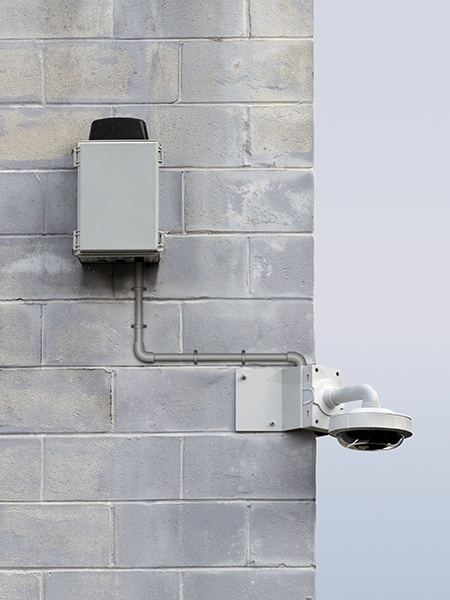 Power unit on a block wall feeding a dome camera on a wall mount
