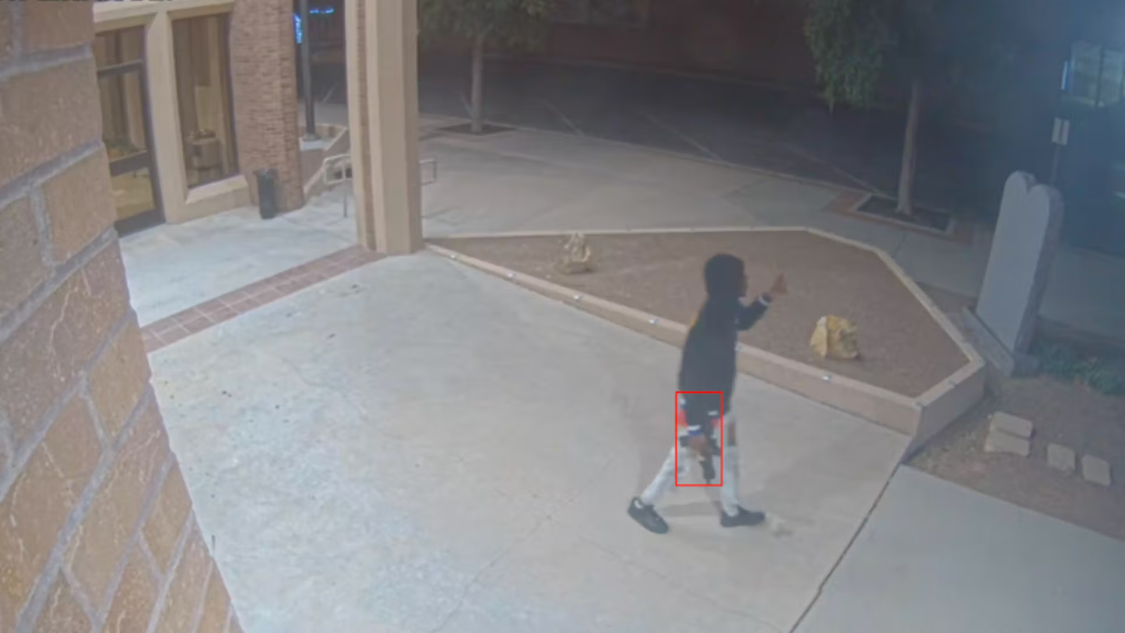 AI threat detection identifying a visible firearm on a live security camera feed