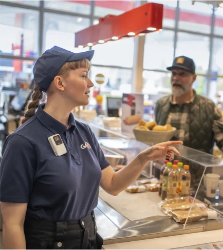 Retail employee wearing a white AXIS body worn camera