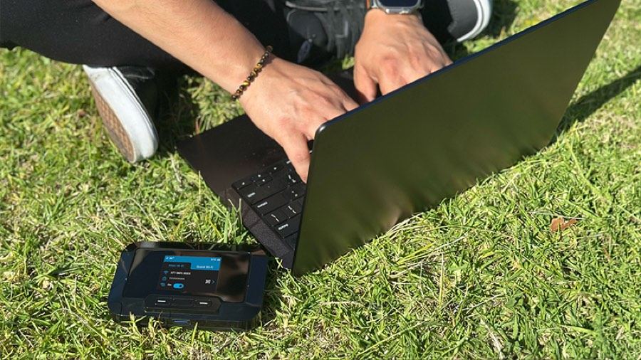 JEXtream 5G mobile hotspot connected to a laptop outdoors